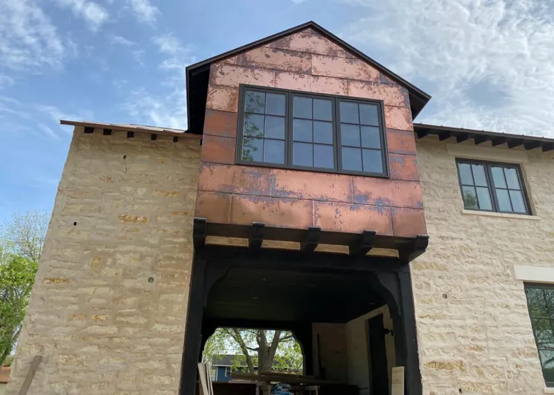 Copper metal panel facade on a stone building for Skylight Installation in Wagoner